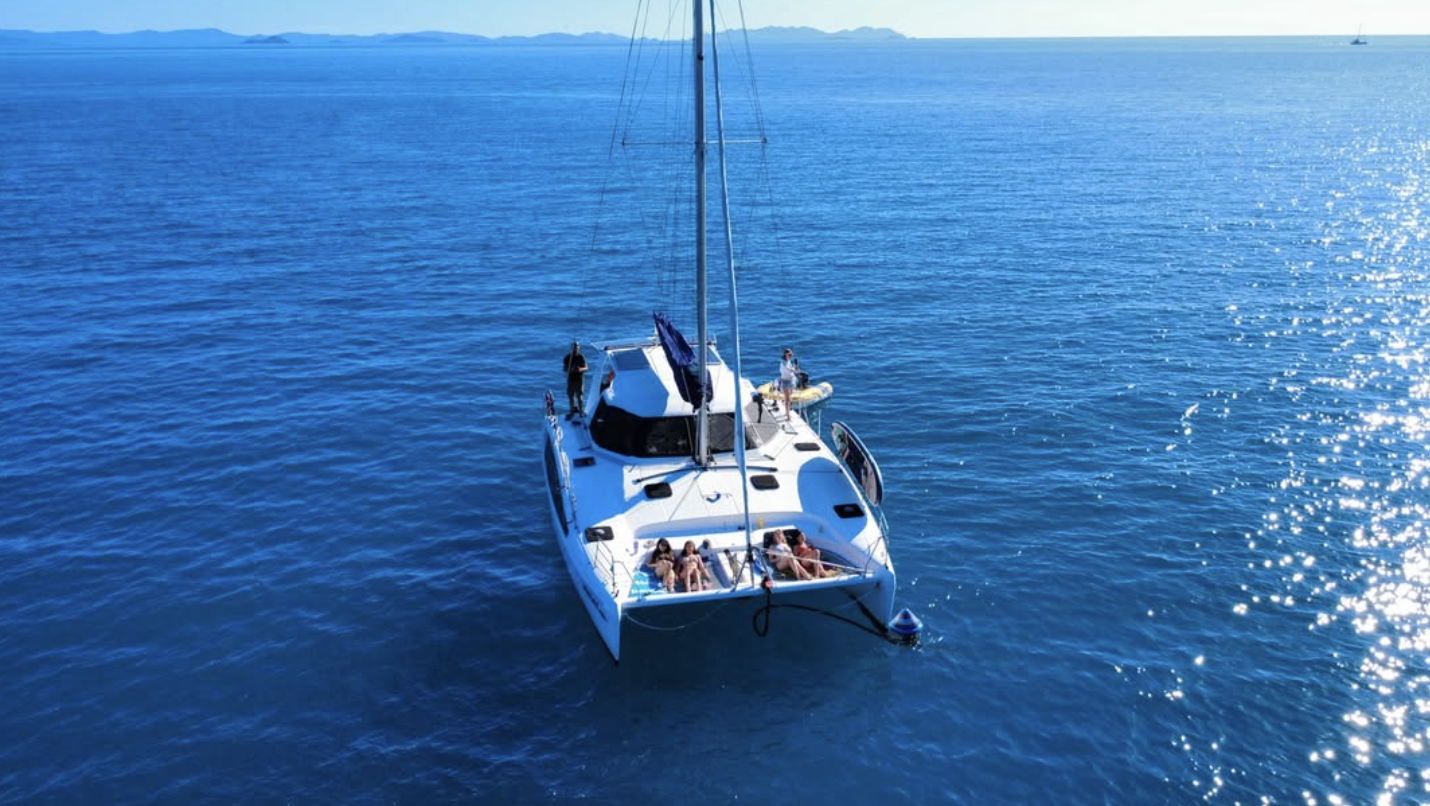 Sailing catamaran on deep blue water