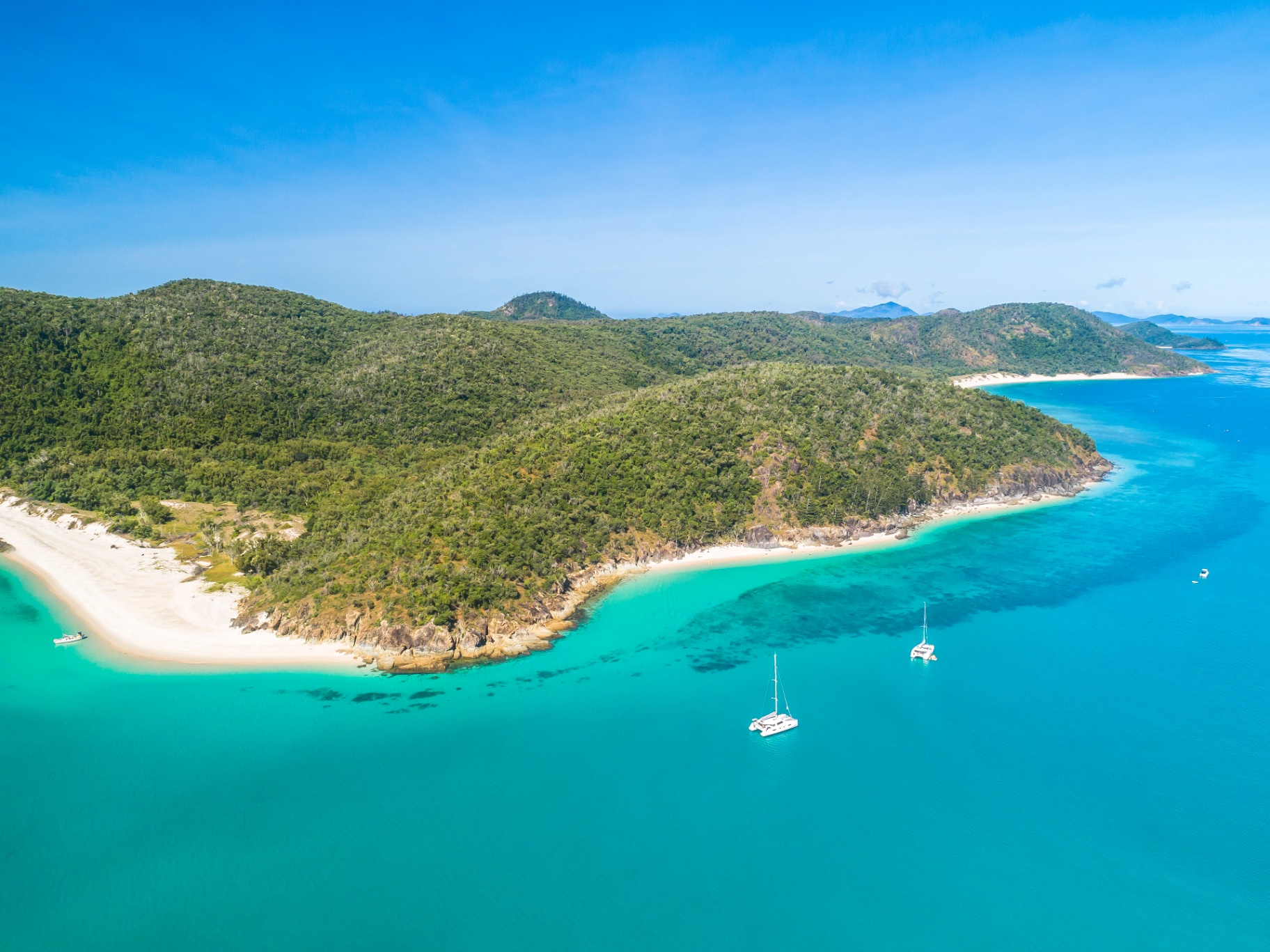 Luxury catamaran anchored off a Whitsunday Islands beach